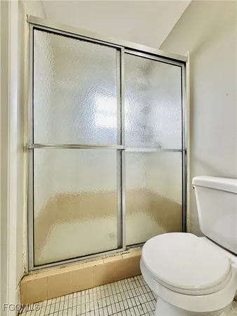 a bathroom with a toilet and a shower