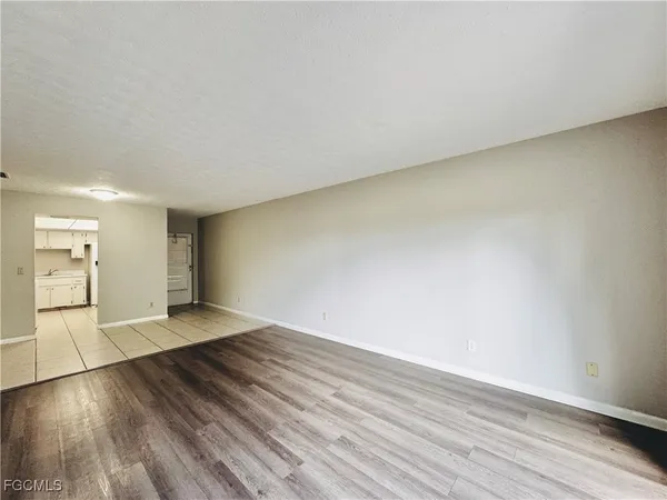 a view of an empty room and wooden floor