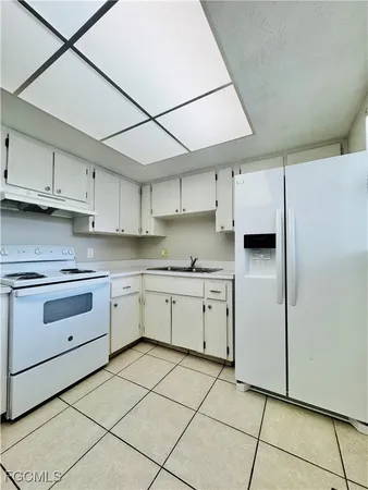 a kitchen with cabinets and appliances