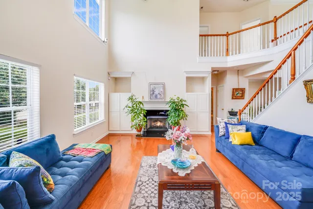 a living room with furniture fireplace and a large window