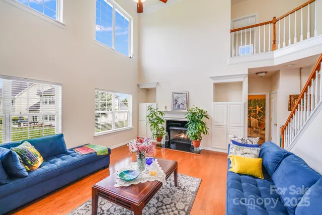 a living room with furniture and a table with wooden floor