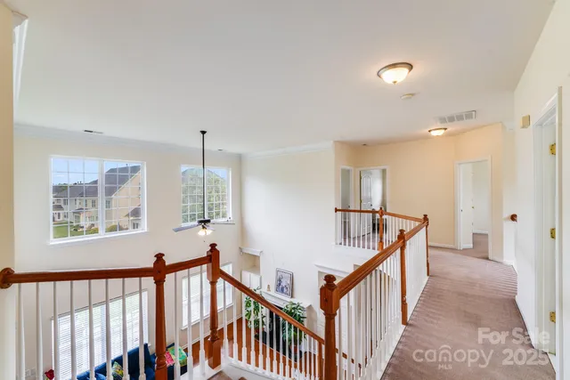 a view of an entryway wooden floor and windows