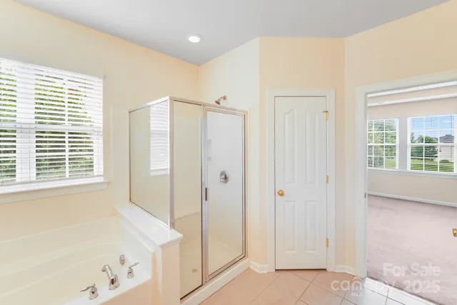 a bathroom with a bathtub and a shower