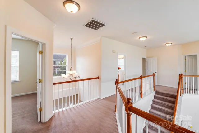 a view of entryway with wooden floor and windows