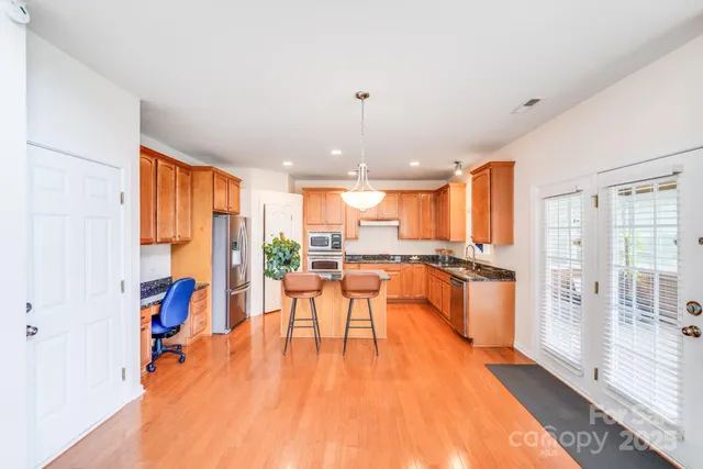 a very nice looking living room with a large window and a dining table