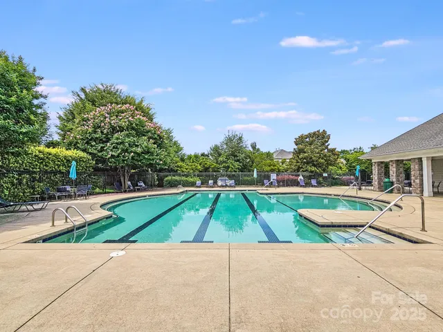 a swimming pool with outdoor seating and yard