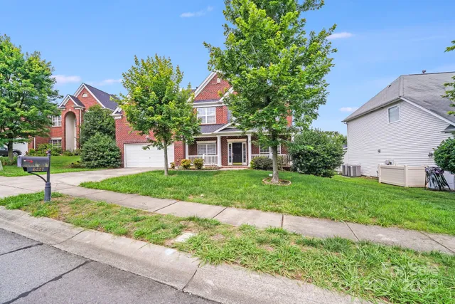 a front view of house with yard and green space