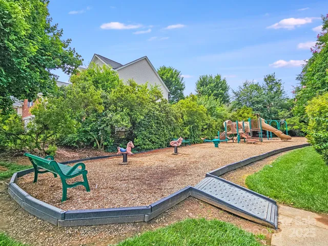 swimming pool with outdoor seating and trees