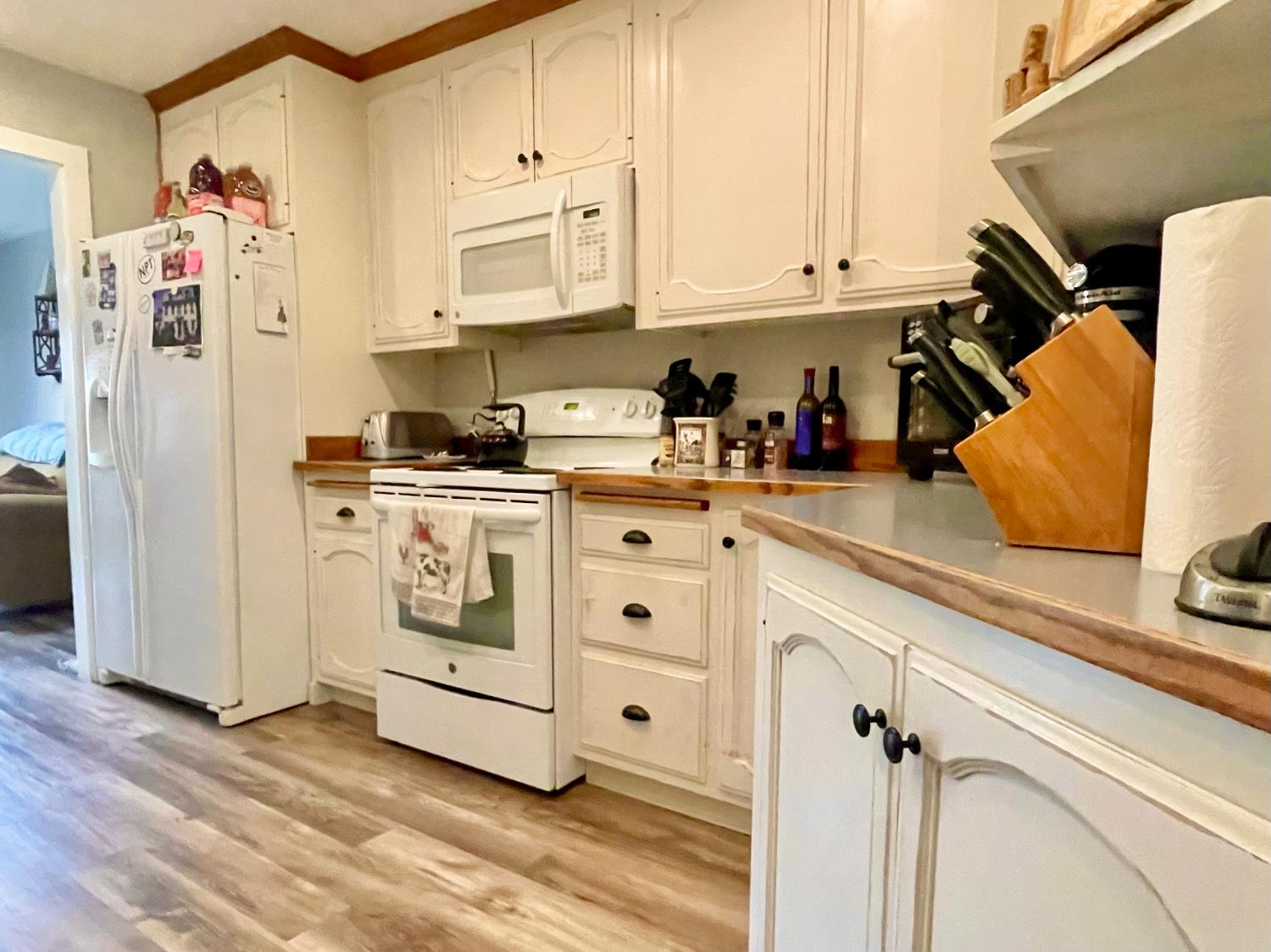 515 Clinton Road Jackson, CA 95642 - Photo 12 of 29 a kitchen with stainless steel appliances white cabinets and wooden floor