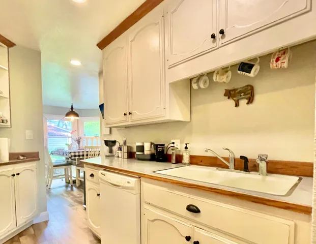 a kitchen with stainless steel appliances granite countertop a sink and cabinets