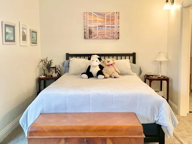 a large bed sitting in a bedroom next to a window