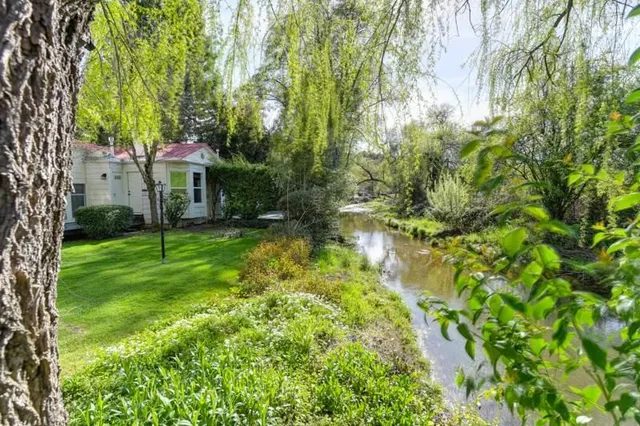 a view of backyard of house with green space