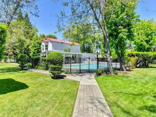 an aerial view of a house with pool outdoor seating and yard