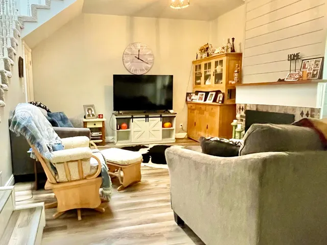 a living room with patio furniture and a flat screen tv