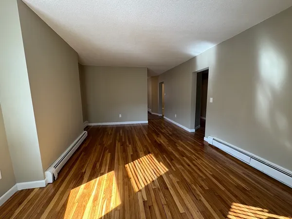 a view of a room with wooden floor