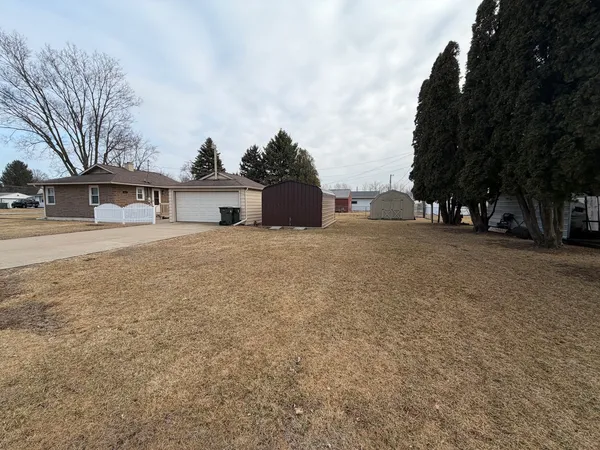 a view of a house with a large trees and a big yard