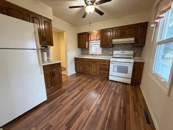 a kitchen with granite countertop wooden cabinets and stainless steel appliances