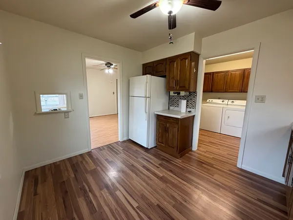 a kitchen with a refrigerator and a stove top oven