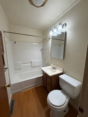 a bathroom with a sink mirror vanity and toilet
