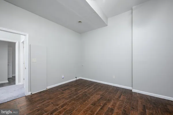 a view of room with wooden floor