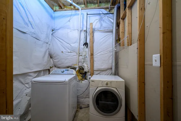 a bathroom with a granite countertop toilet and a sink