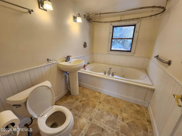 a bathroom with a sink a toilet and bathtub