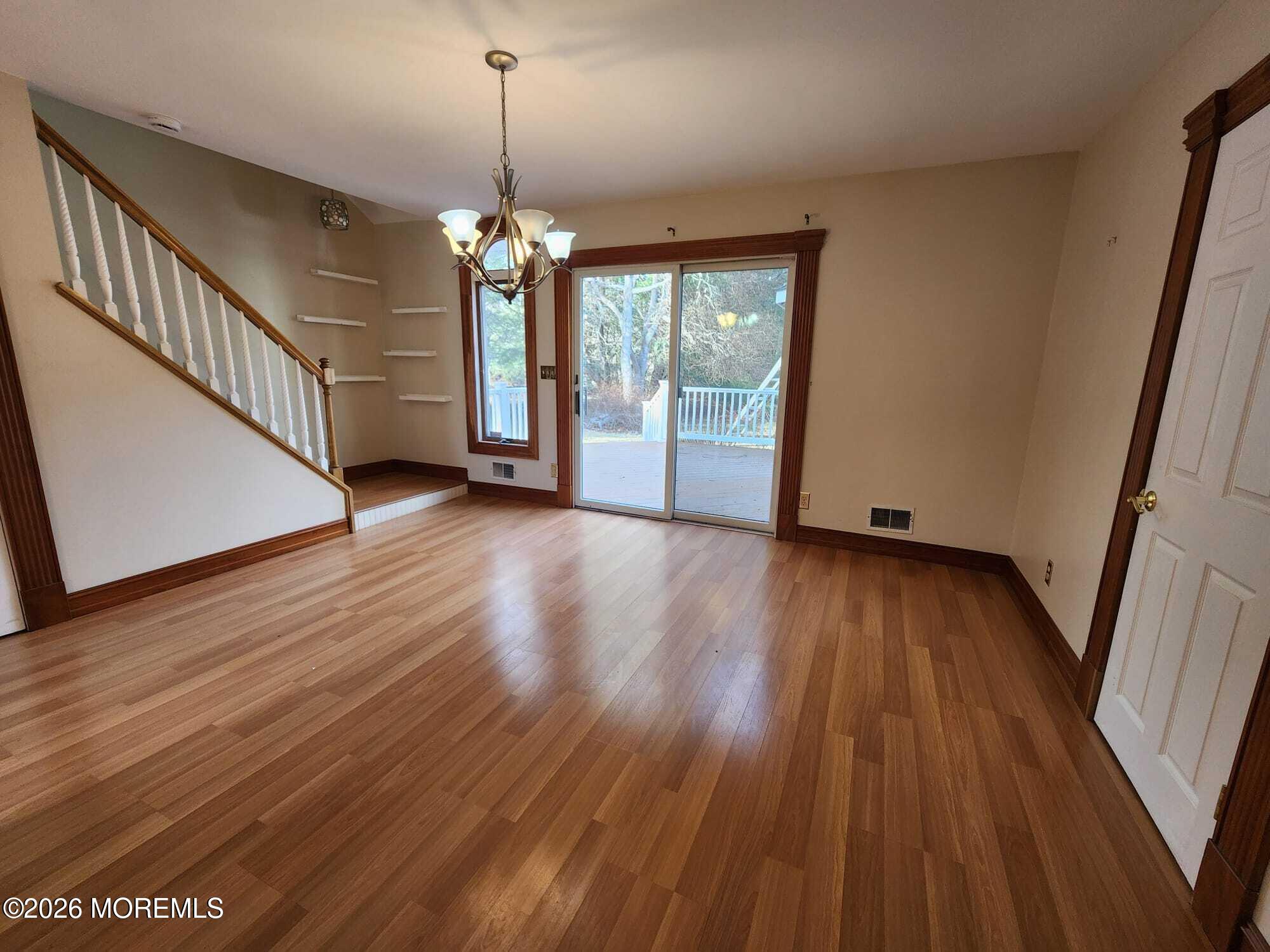 426 Bennetts Mills Road Jackson, NJ 08527 - Photo 4 of 20 wooden floor in an empty room with a window