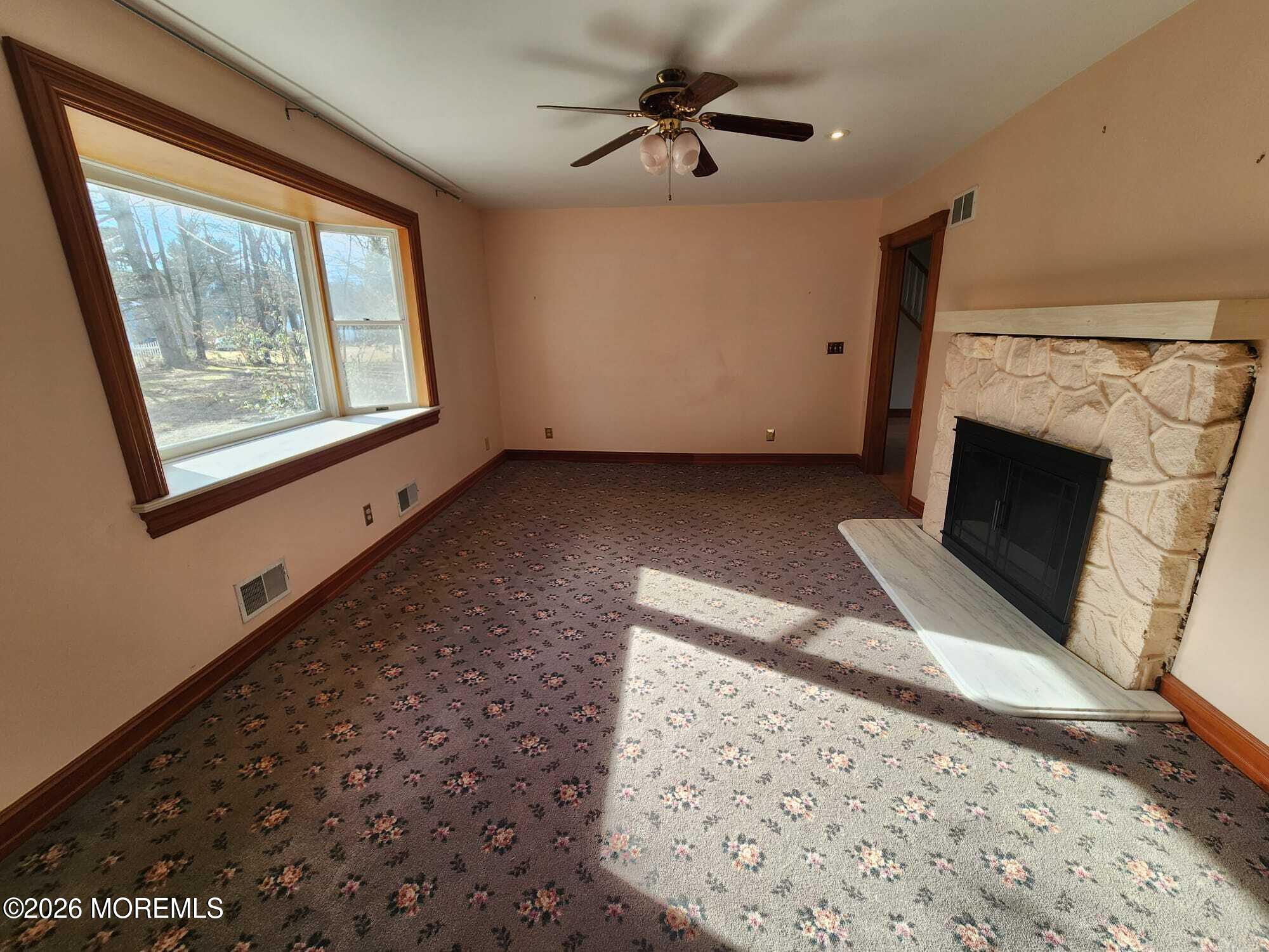426 Bennetts Mills Road Jackson, NJ 08527 - Photo 6 of 20 a view of an empty room with a fireplace and a window