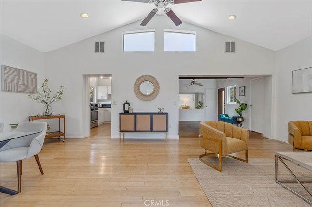 a living room with furniture and a clock
