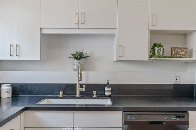 a hallway with mirror cabinets and window