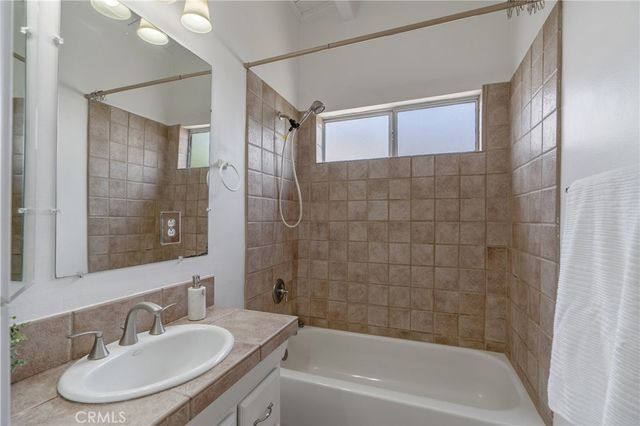 a bedroom with a bed wooden floor and windows