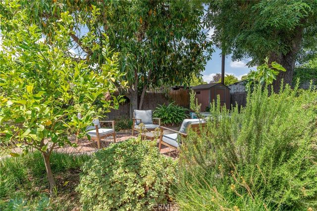 a view of patio with chairs and table under an umbrella
