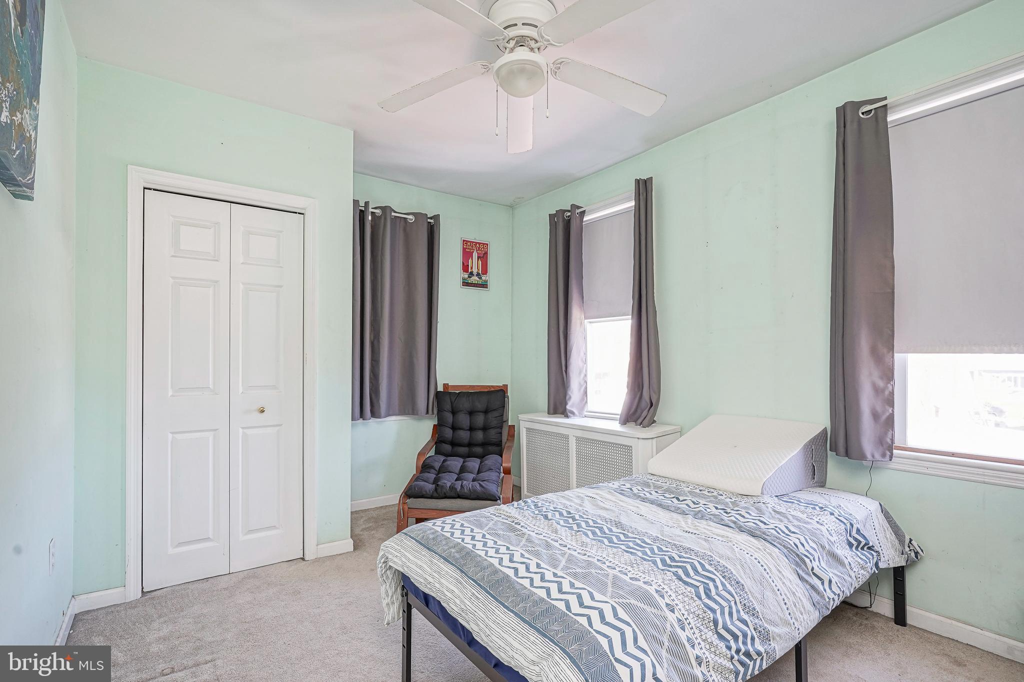 1919 Lansing Street Philadelphia, PA 19111 - Photo 15 of 22 a bedroom with a bed and a chandelier