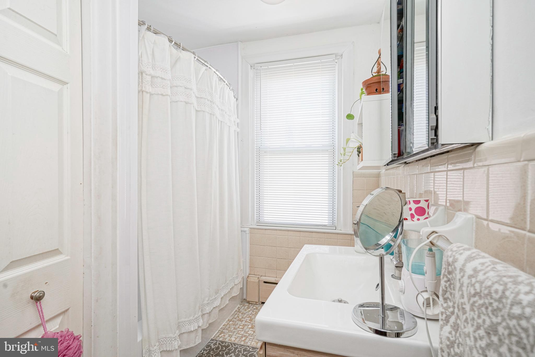 1919 Lansing Street Philadelphia, PA 19111 - Photo 16 of 22 a bathroom with a sink and a mirror