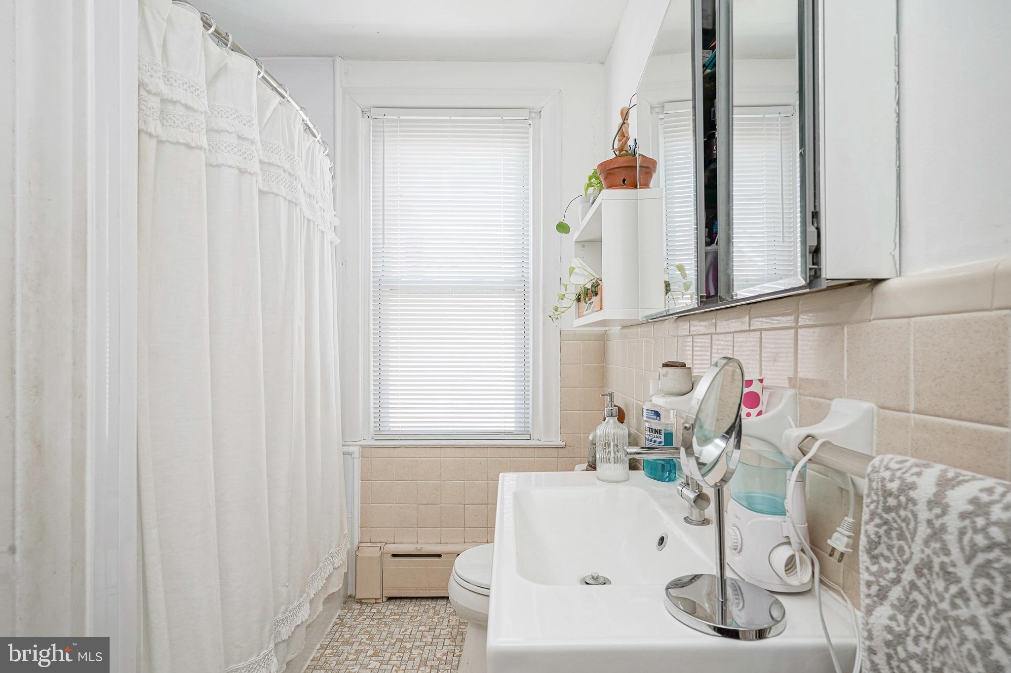 1919 Lansing Street Philadelphia, PA 19111 - Photo 17 of 22 a bathroom with a sink and a mirror