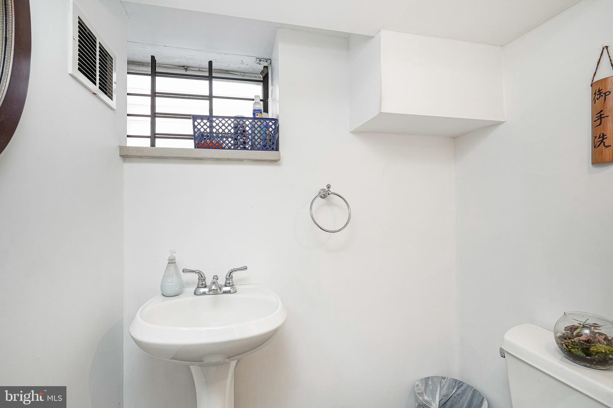 1919 Lansing Street Philadelphia, PA 19111 - Photo 19 of 22 a bathroom with a sink a mirror and a window