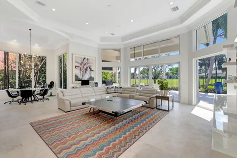 a kitchen with kitchen island a dining table chairs cabinets and stainless steel appliances