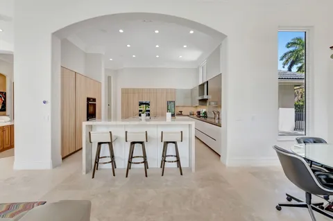 a kitchen with stainless steel appliances granite countertop a sink a stove and a refrigerator