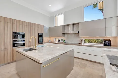 a kitchen with stainless steel appliances a refrigerator and white cabinets
