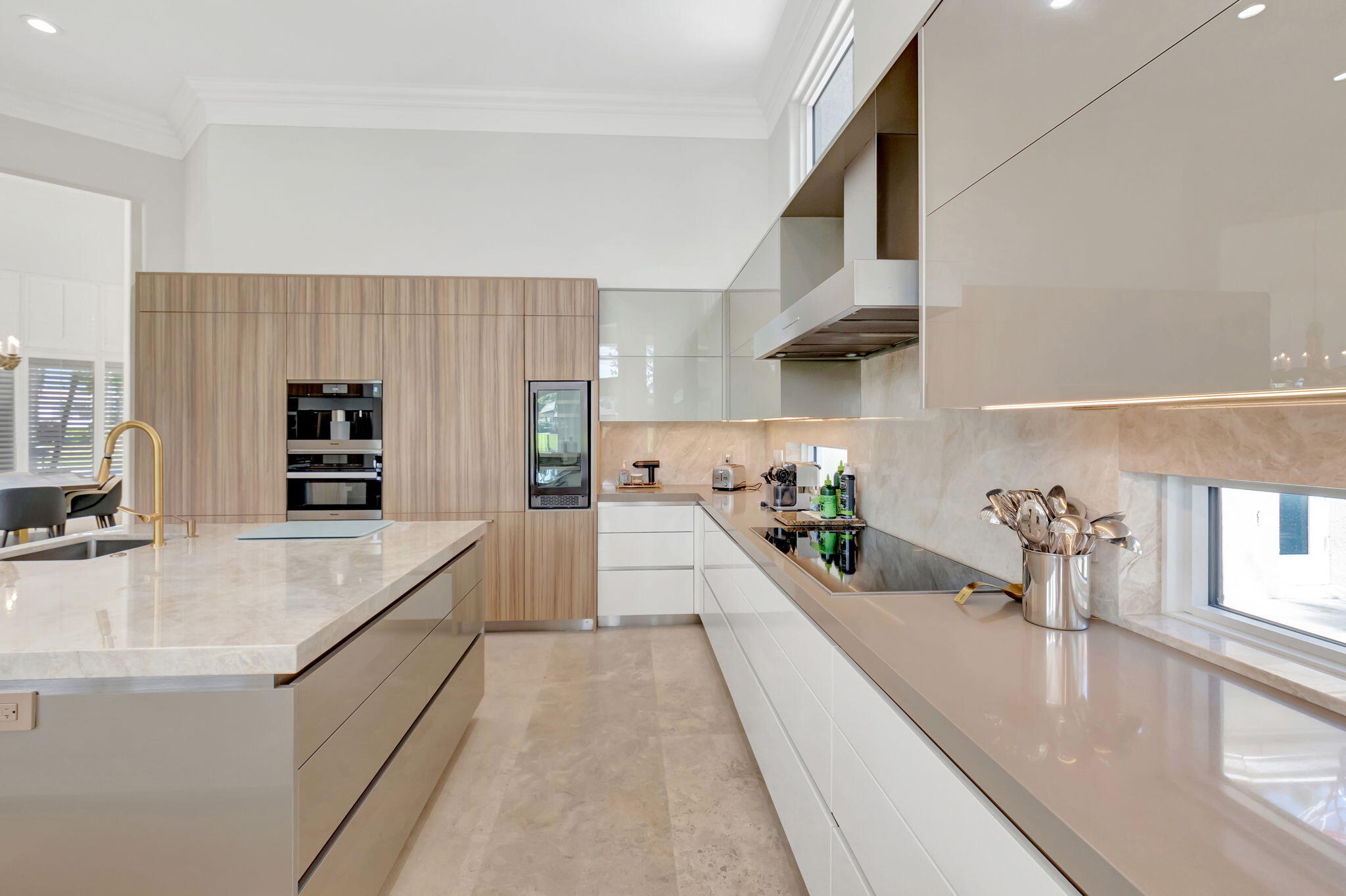 7090 Ayrshire Lane Boca Raton, FL 33496 - Photo 19 of 48 a large white kitchen with sink and wooden floor