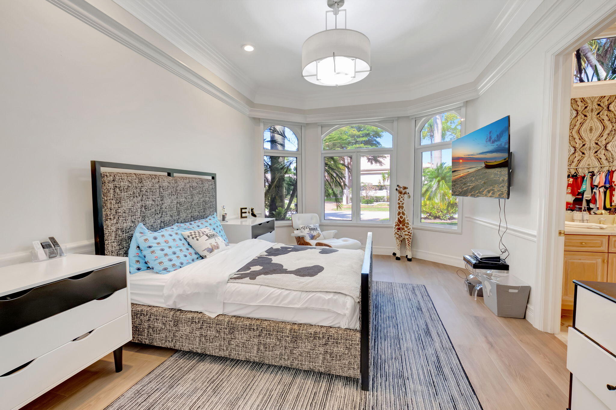 7090 Ayrshire Lane Boca Raton, FL 33496 - Photo 24 of 48 a bedroom with a large bed and a wooden floor