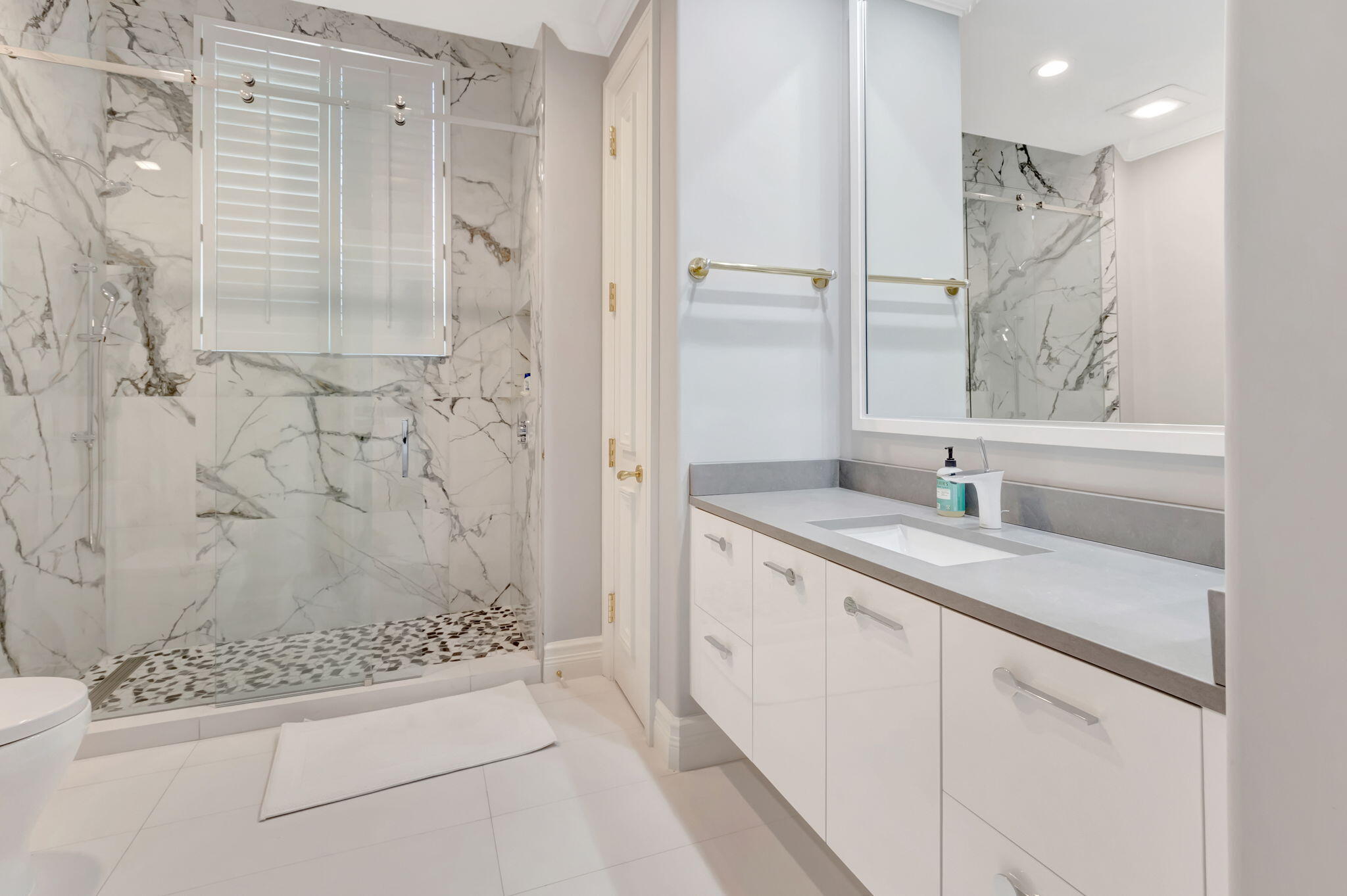 7090 Ayrshire Lane Boca Raton, FL 33496 - Photo 31 of 48 a bathroom with a granite countertop sink a mirror a vanity and a shower