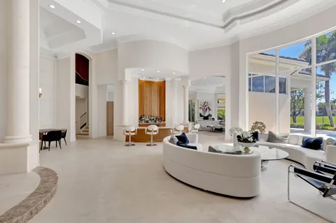 a living room with fireplace furniture and a large window