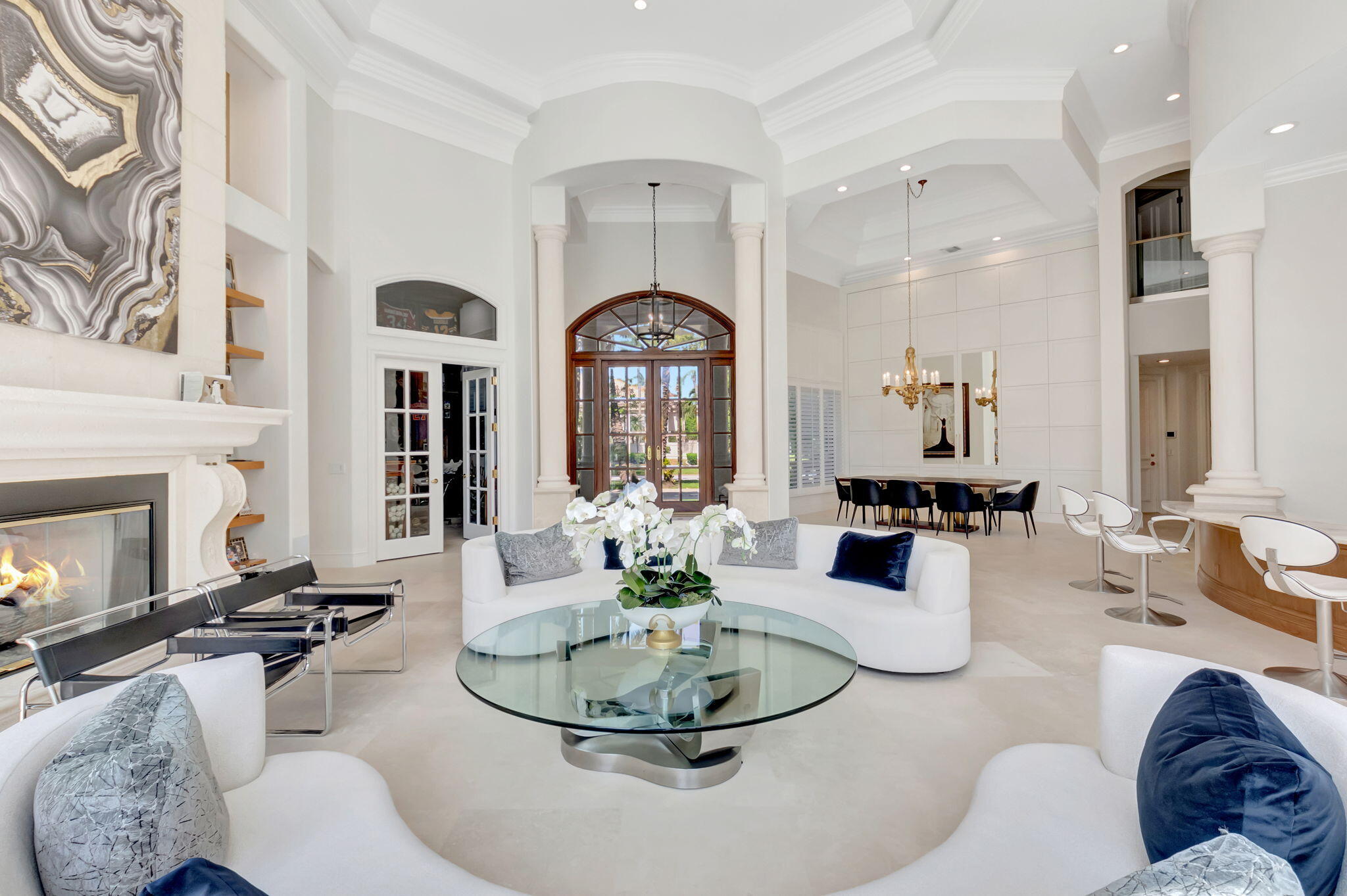 7090 Ayrshire Lane Boca Raton, FL 33496 - Photo 9 of 48 a living room with furniture a fireplace and a chandelier