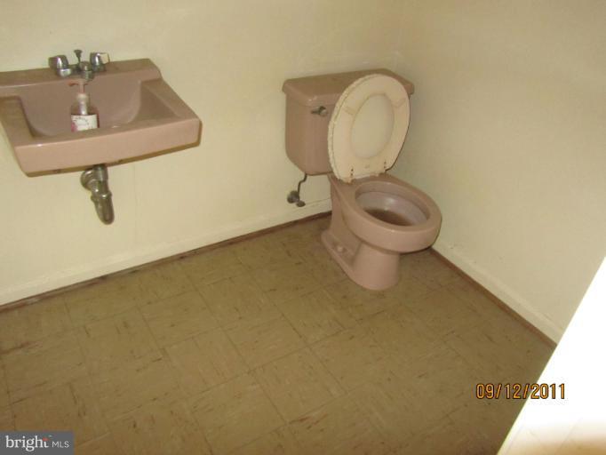 6923 Vancouver Road Springfield, VA 22152 - Photo 11 of 13 a bathroom with a toilet sink and mirror