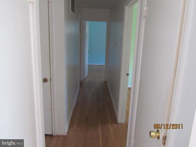 6923 Vancouver Road Springfield, VA 22152 - Photo 13 of 13 a view of a hallway with wooden floor