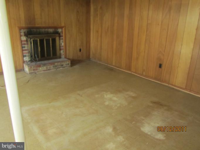6923 Vancouver Road Springfield, VA 22152 - Photo 5 of 13 a view of an empty room with a fireplace