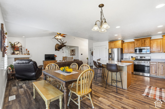 9044 North Cedar Pass Road Eagle Mountain, UT 84005 - Photo 15 of 63 Spacious kitchen featuring stainless steel appliances, light wood-finish cabinetry, and a kitchen island with seating