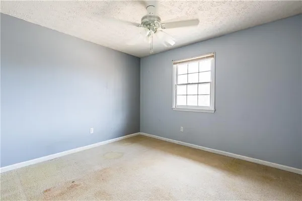 an empty room with windows and closet