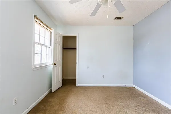 a view of room with wooden floor and windows